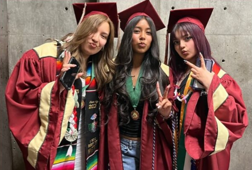 three girls in grad gowns